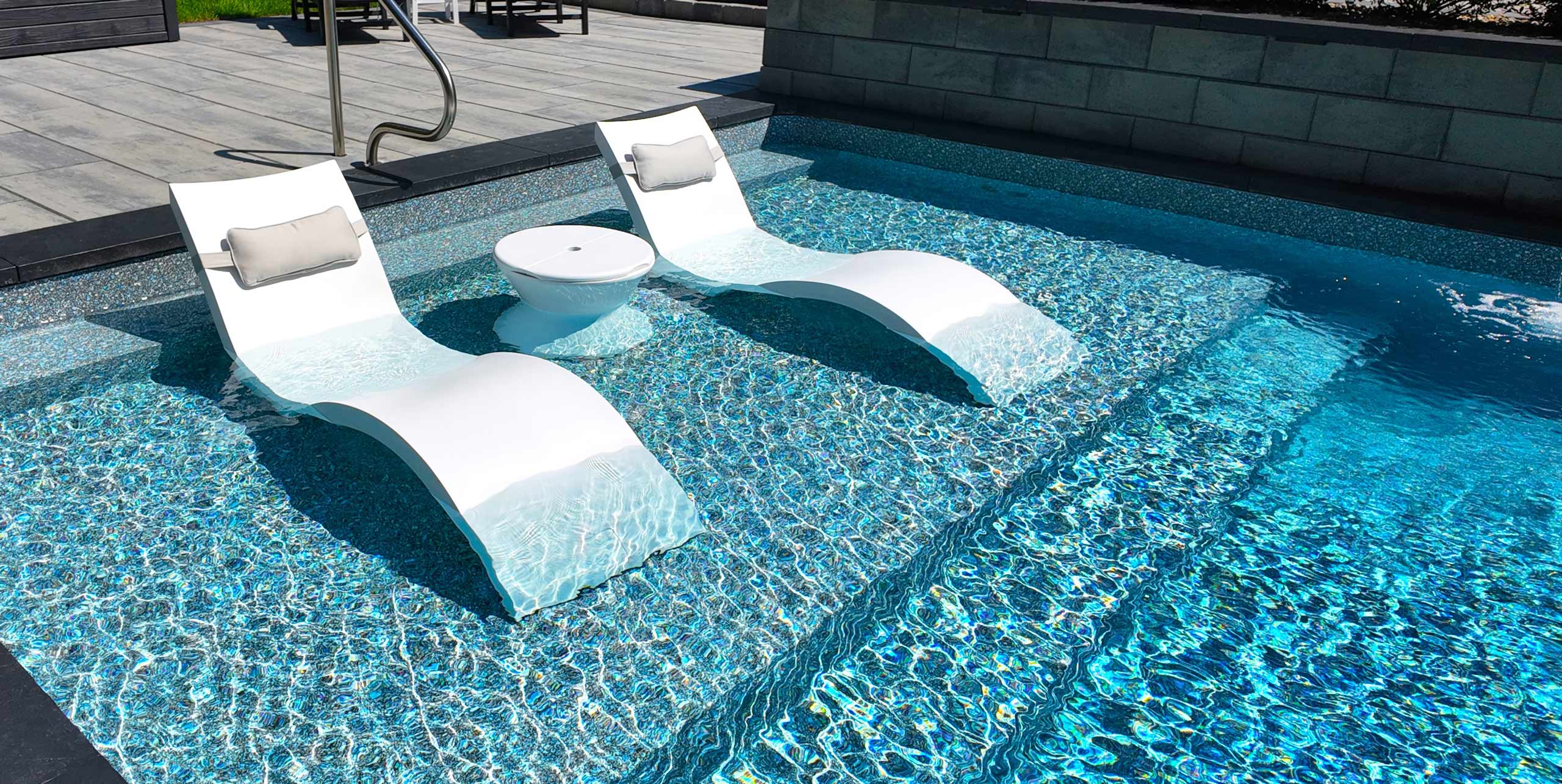 Large tanning ledge with lounge chairs in shallow end of pool